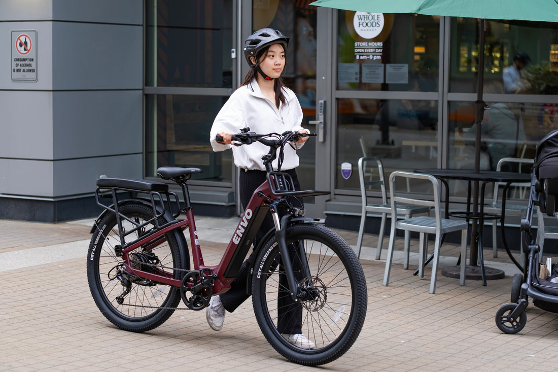 Woman with ENVO electric step-through e-bike stopped outside a city building
