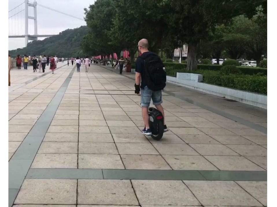 man rides electric unicycle